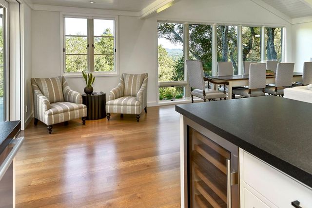 a living room with furniture and large windows