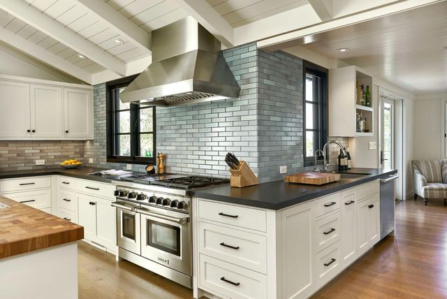 a kitchen with cabinets appliances a sink and a counter top space