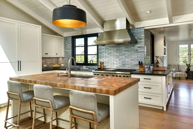 a kitchen with a stove a sink and a refrigerator