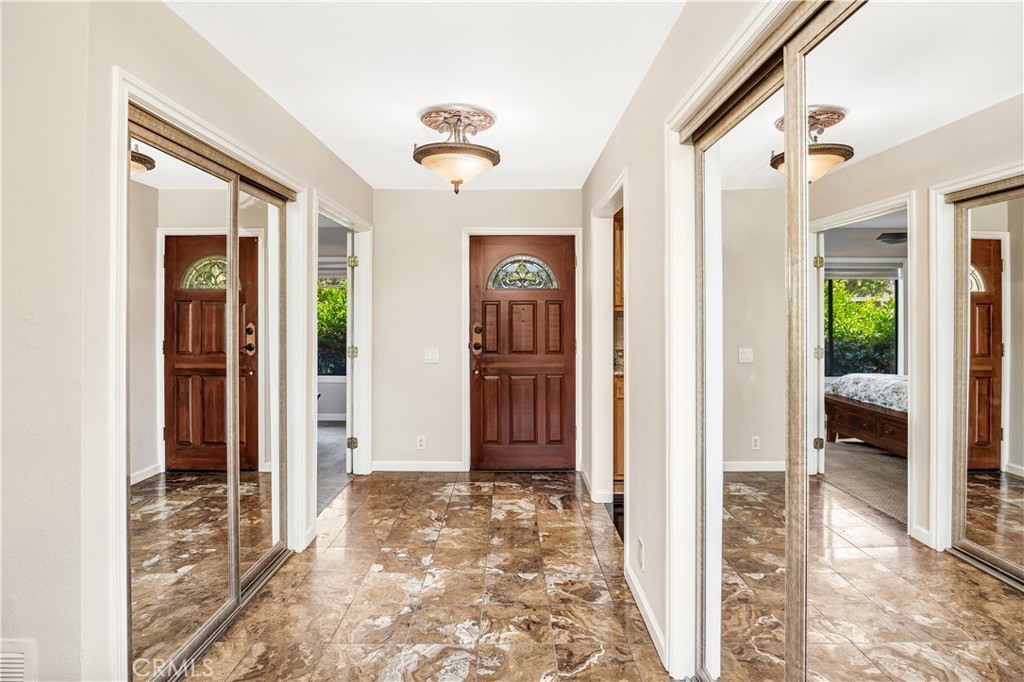 3 Palos, Unit 51 Irvine, CA 92612 - Photo 13 of 40 The view of the front door and entry, two closets are flanking the tiled hallway. The second bedroom is to the left and the kitchen is to the right.