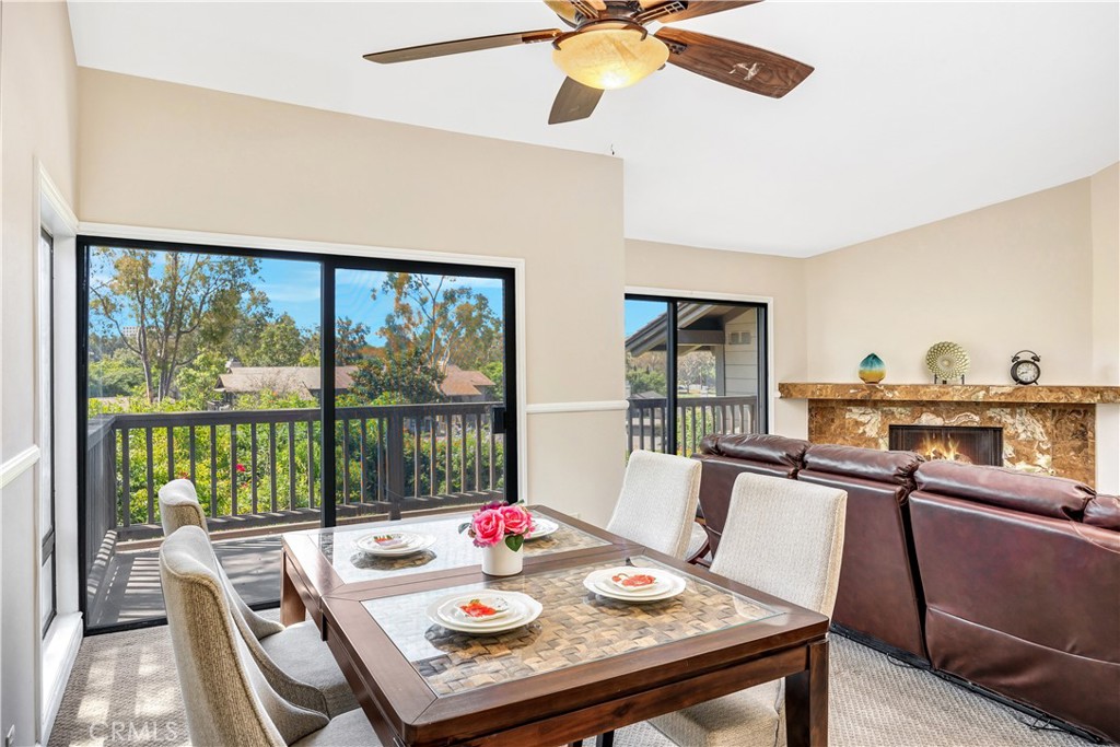 3 Palos, Unit 51 Irvine, CA 92612 - Photo 15 of 54 The dining room with another set of sliding rooms. A beautiful view of the tree top and the blue sky beyond!