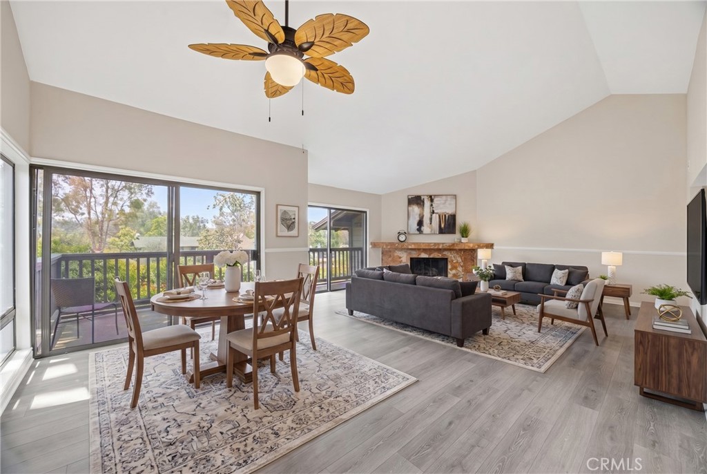 3 Palos, Unit 51 Irvine, CA 92612 - Photo 2 of 40 Another view of the dining room and living room with high ceiling, and two sets of sliding doors leads to the balcony with view of the blooming plants and very private.