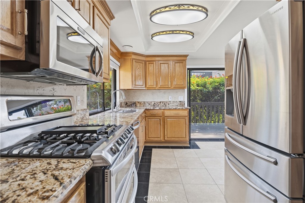 3 Palos, Unit 51 Irvine, CA 92612 - Photo 6 of 40 Another view of the kitchen with stainless steel appliances.