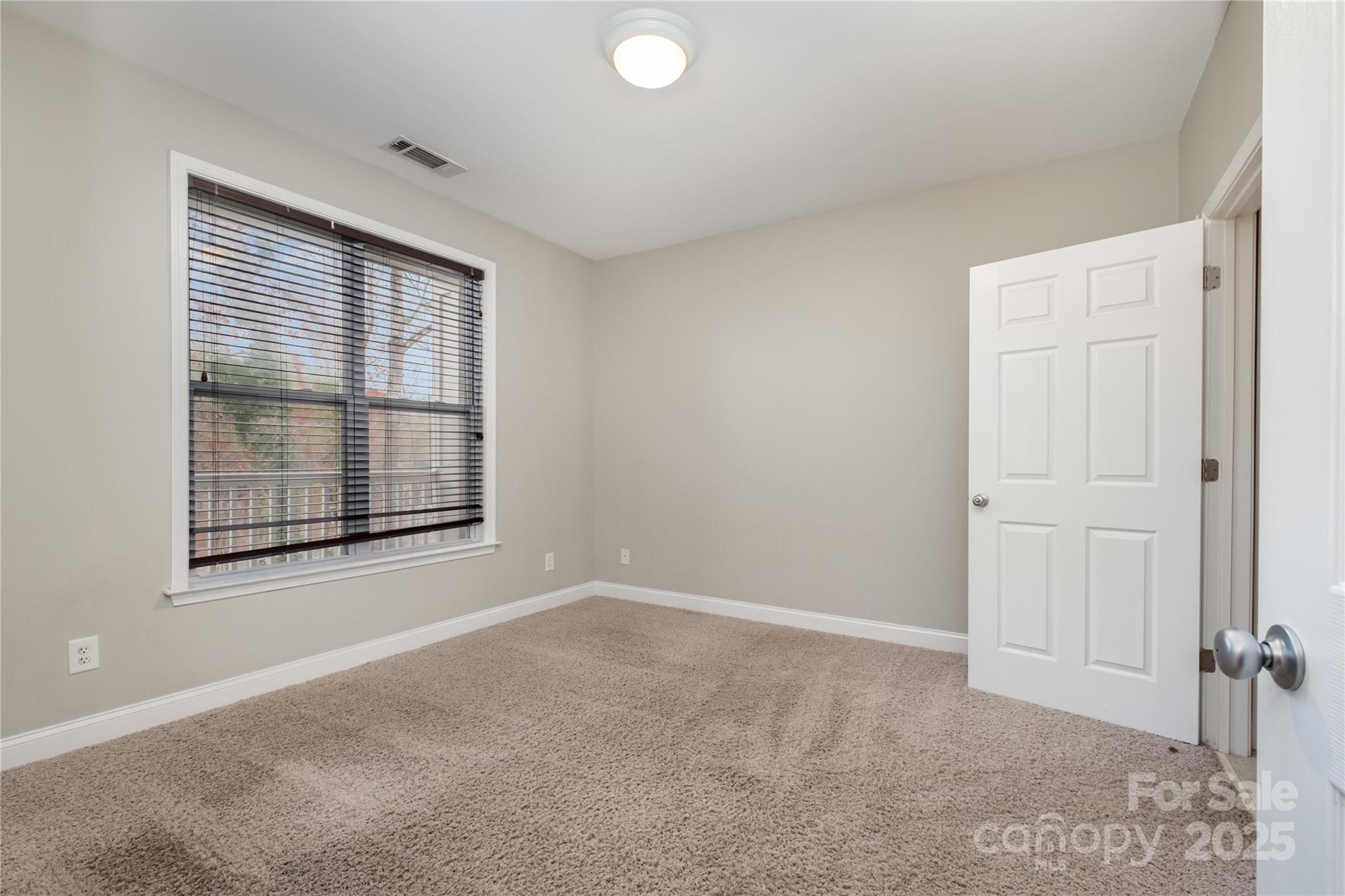 1000 East Woodlawn Road, Unit 217 Charlotte, NC 28209 - Photo 12 of 19 an empty room with windows and closet