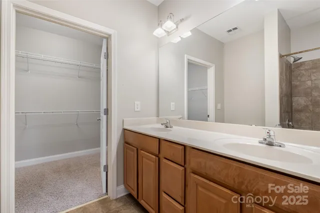 a bathroom with a double vanity sink and a mirror