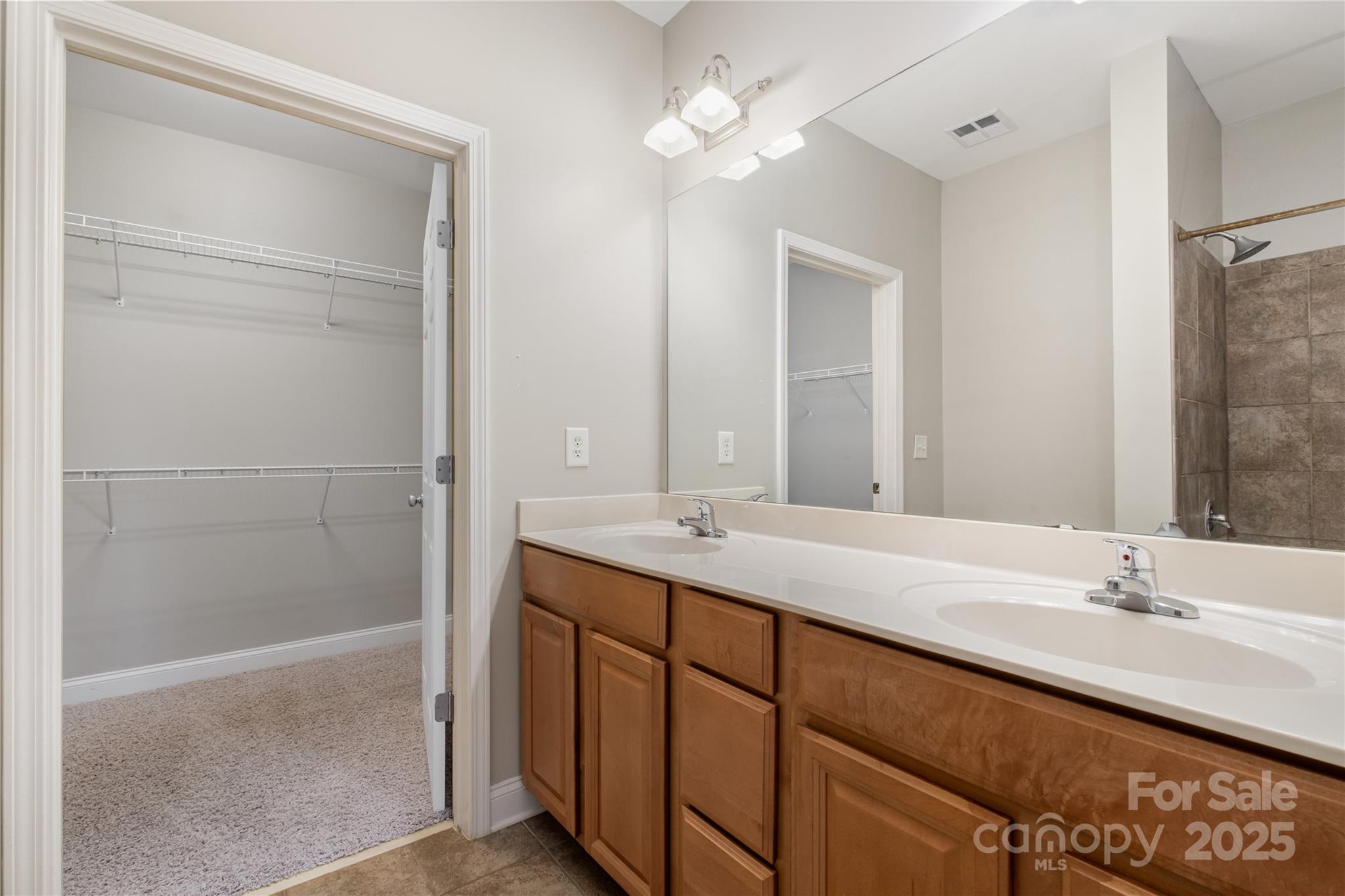 1000 East Woodlawn Road, Unit 217 Charlotte, NC 28209 - Photo 14 of 19 a bathroom with a double vanity sink and a mirror