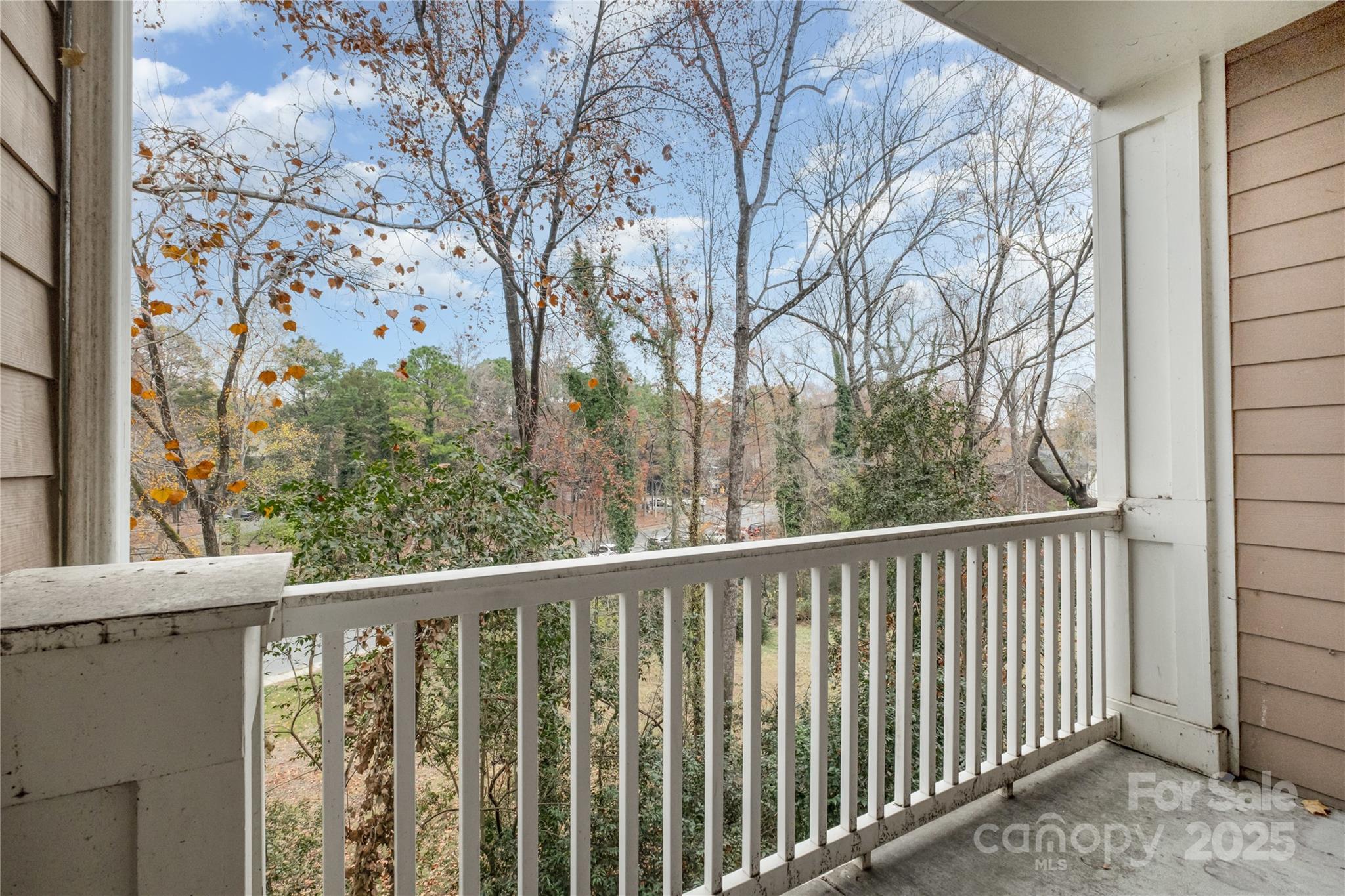 1000 East Woodlawn Road, Unit 217 Charlotte, NC 28209 - Photo 17 of 19 a view of a balcony with wooden fence and floor
