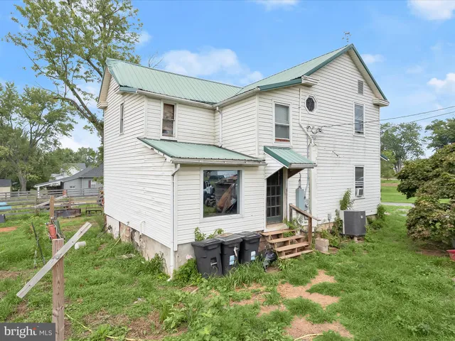 a front view of house with a garden