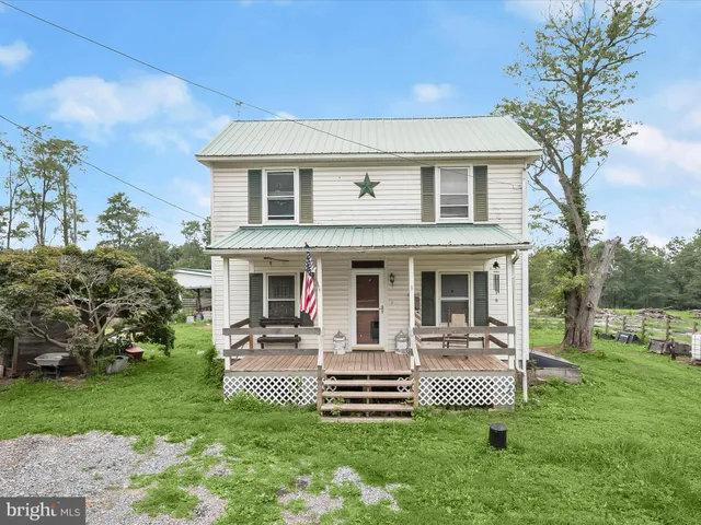 a front view of house with a garden