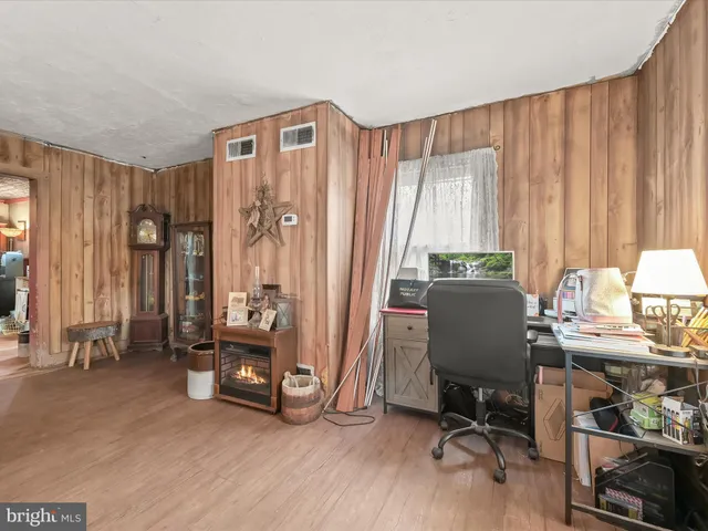 a view of a workspace with furniture and a window