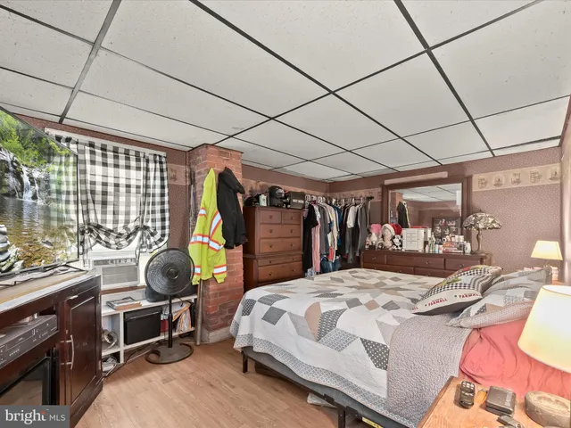 a bedroom with a bed a desk and chair