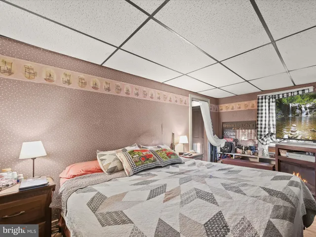 a bed room with a bed and a chair