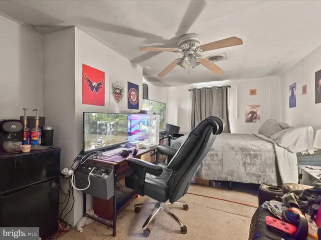 a bedroom with furniture and a chandelier fan