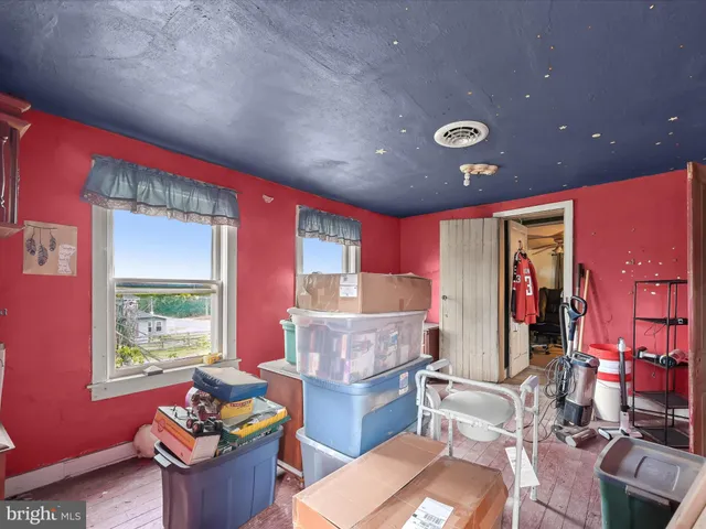 a living room with furniture a window and a chandelier