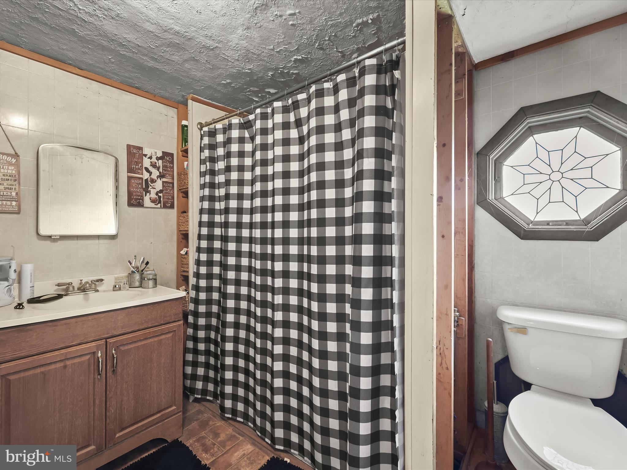 430 Bucher John Road Union Bridge, MD 21791 - Photo 36 of 40 a bathroom with a toilet sink vanity and mirror