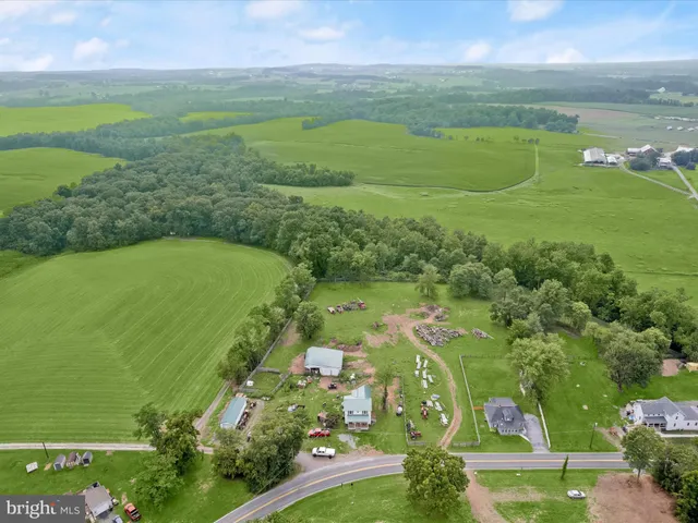 an aerial view of ocean with residential houses with outdoor space and swimming pool