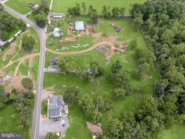 an aerial view of residential houses with outdoor space and swimming pool