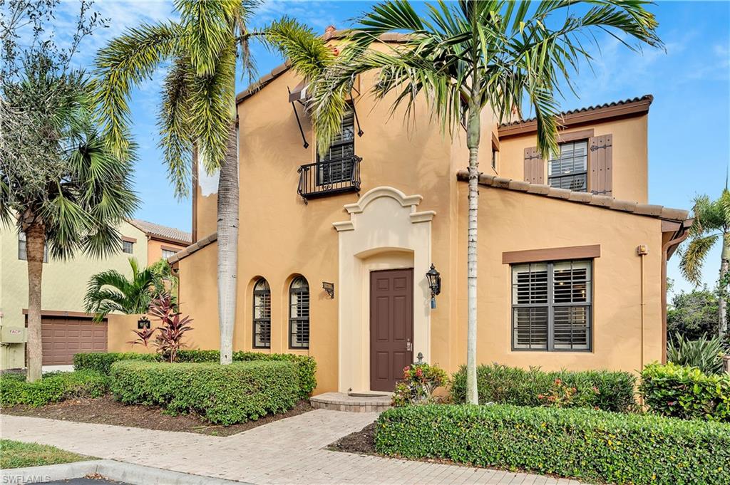 9154 Chula Vista Street, Unit 1331 Naples, FL 34113 - Photo 1 of 25 front view of house with a palm plants