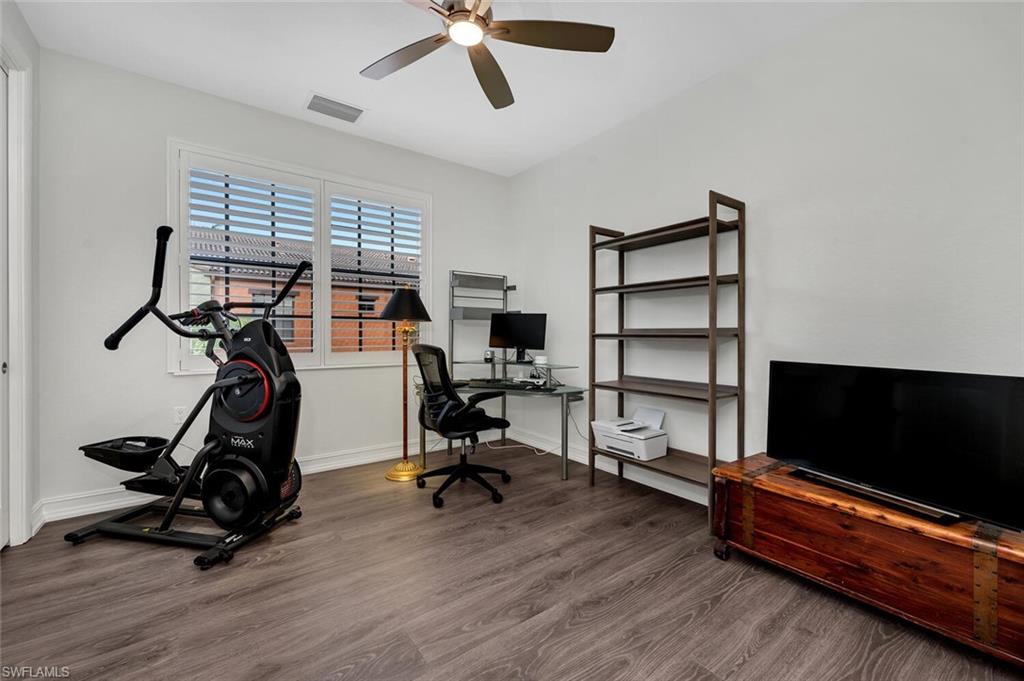 9154 Chula Vista Street, Unit 1331 Naples, FL 34113 - Photo 12 of 25 a view of a workspace with furniture and a flat screen tv
