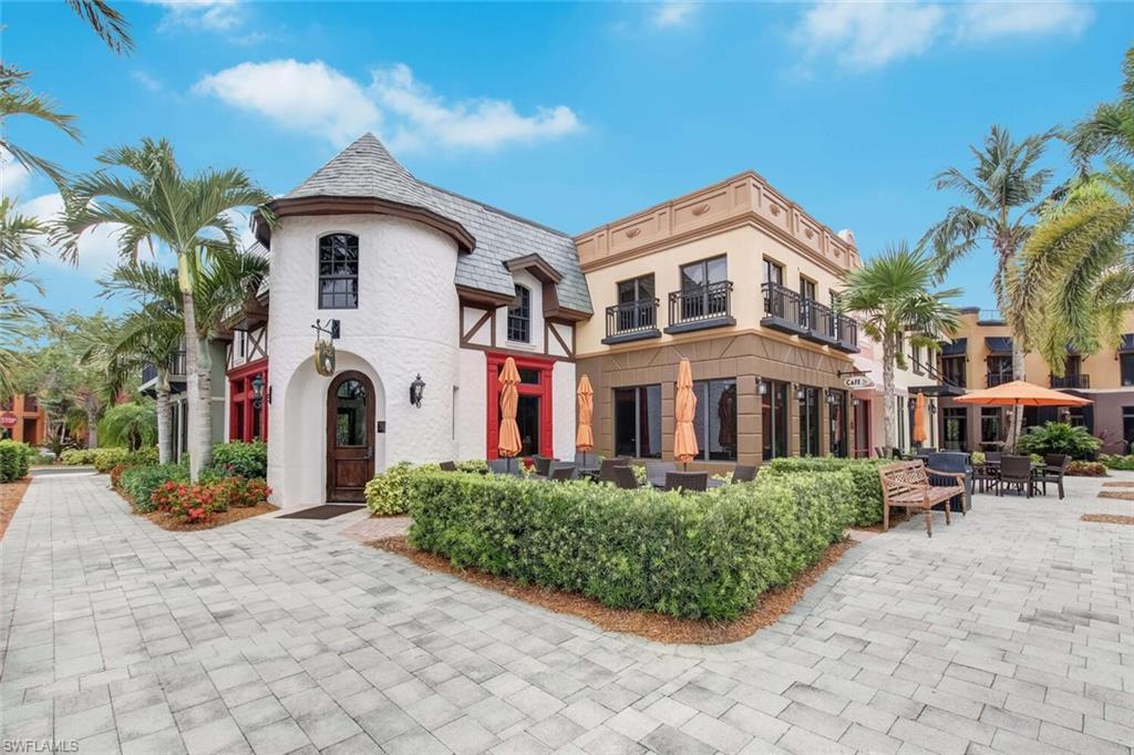 9154 Chula Vista Street, Unit 1331 Naples, FL 34113 - Photo 19 of 25 a front view of a house with a yard