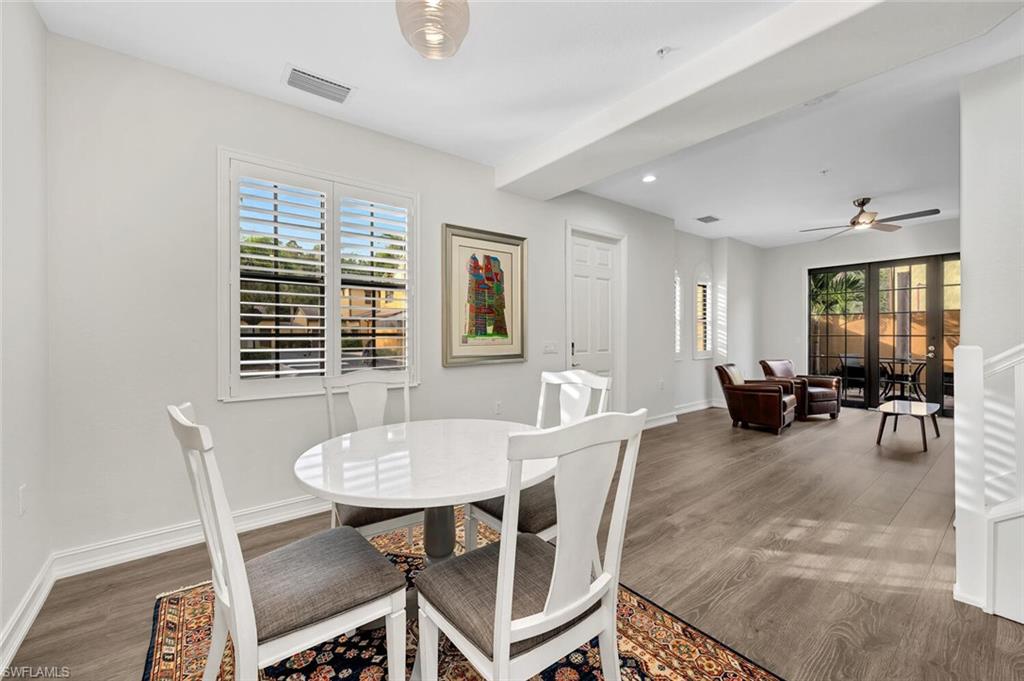 9154 Chula Vista Street, Unit 1331 Naples, FL 34113 - Photo 5 of 25 a view of a dining room with furniture and a potted plant