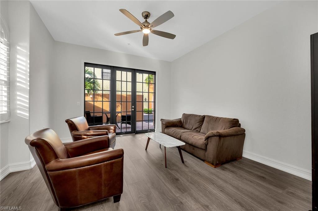 9154 Chula Vista Street, Unit 1331 Naples, FL 34113 - Photo 6 of 25 a living room with furniture and a large window
