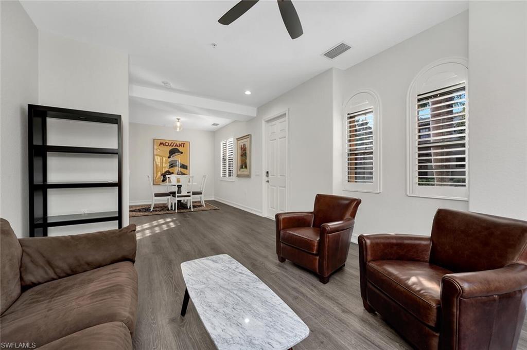 9154 Chula Vista Street, Unit 1331 Naples, FL 34113 - Photo 7 of 25 a living room with furniture and a window