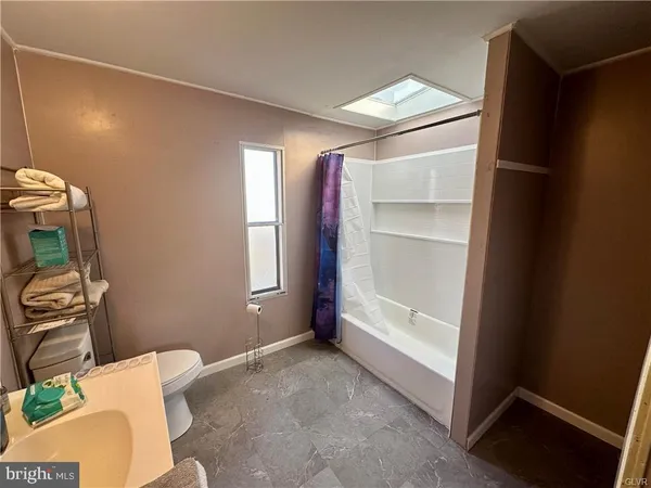 a view of room with window and furniture
