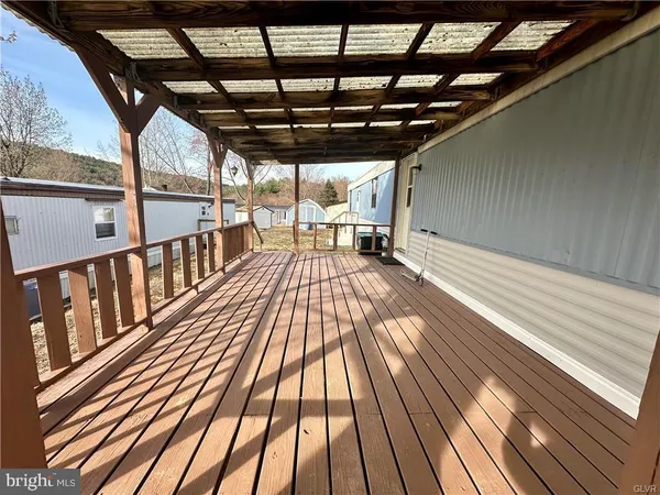 a view of outdoor space with wooden floor
