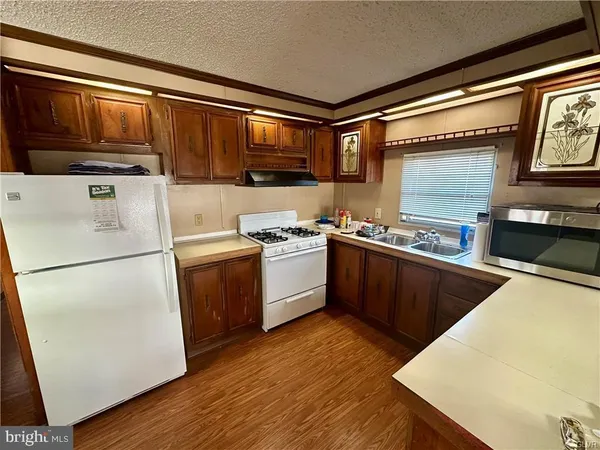a kitchen with a stove a sink and a refrigerator