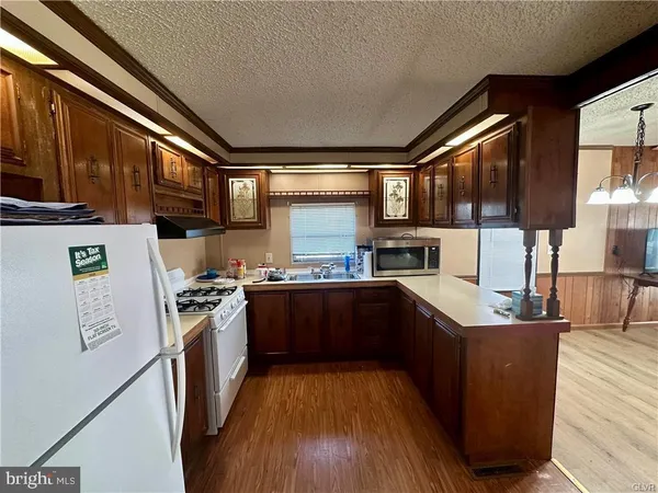 a kitchen with stainless steel appliances granite countertop a stove a sink dishwasher and a refrigerator