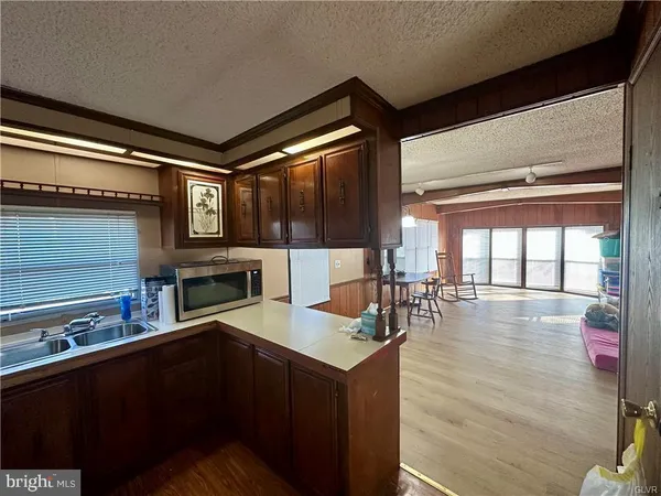 a kitchen with sink refrigerator and large window