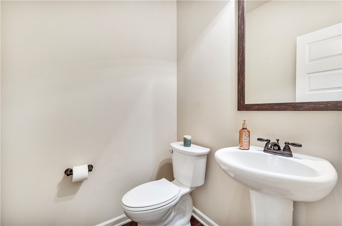 144 Buckland Drive Anderson, SC 29621 - Photo 38 of 48 A well-appointed powder room features a pedestal sink and contemporary toilet for everyday convenience.