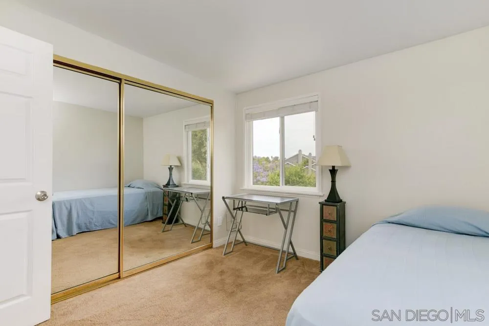 433 Village Run East Encinitas, CA 92024 - Photo 16 of 25 a bedroom with a bed and a table in it