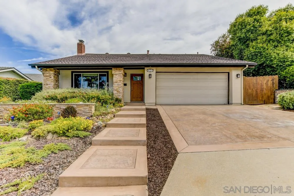 433 Village Run East Encinitas, CA 92024 - Photo 2 of 25 a front view of a house with a yard and potted plants