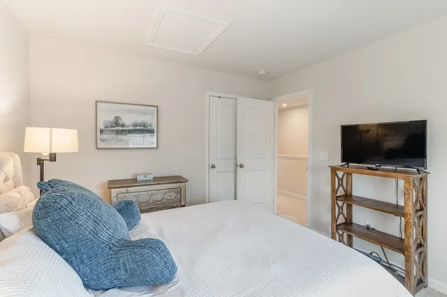 a bedroom with a bed and a flat screen tv