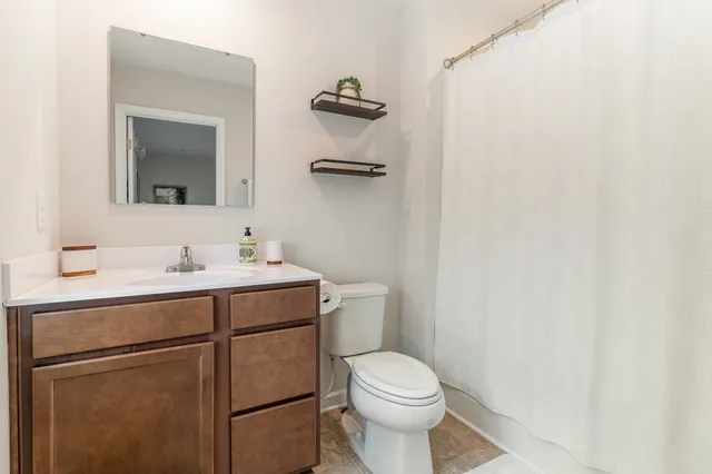 a bathroom with a sink a toilet and mirror