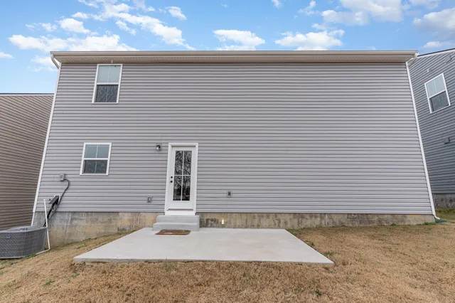a side view of a house with a yard and garage