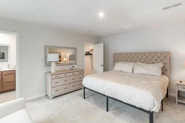 a bedroom with a bed and a dresser