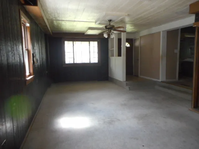 a view of a porch with wooden floor and windows