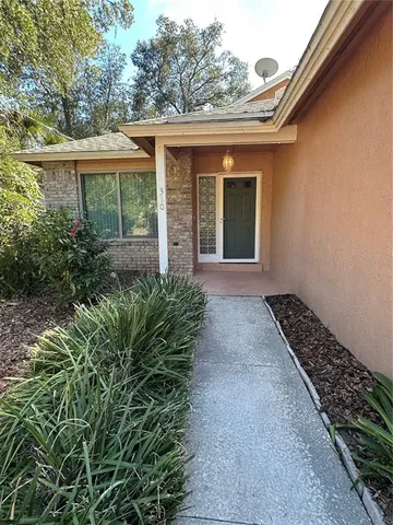 front view of a house with a large window