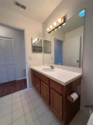a bathroom with a sink a vanity and a mirror