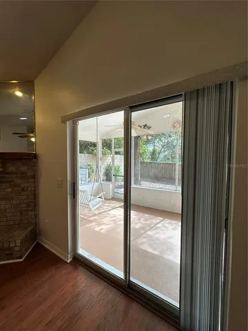 a view of a room with wooden floor and doors