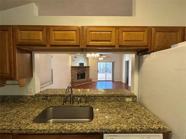 a kitchen with stainless steel appliances granite countertop a sink stove and cabinets