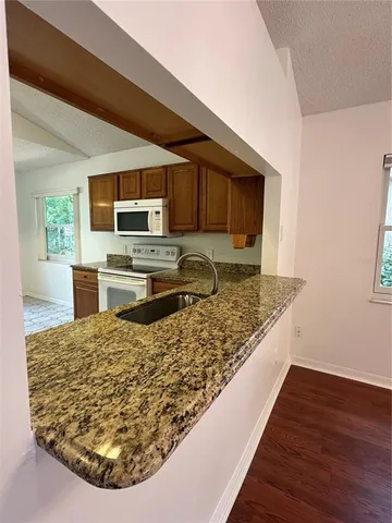 a kitchen with wooden floor and a sink