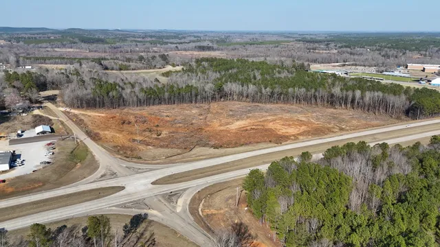 a view of a water pond with green field