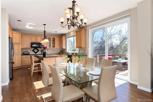 a view of a dining room with furniture wooden floor and chandelier