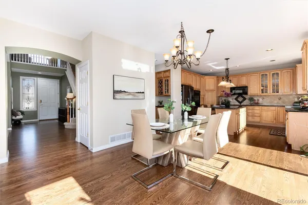 a living room with kitchen island furniture and a chandelier