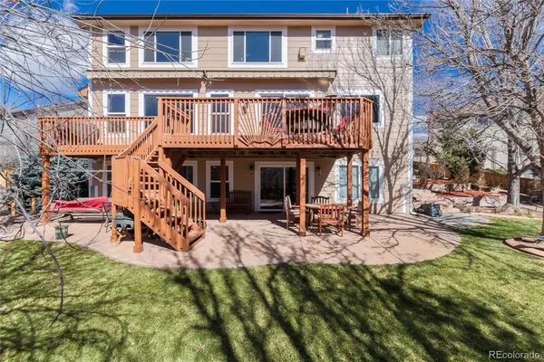 a view of a house with backyard porch and sitting area
