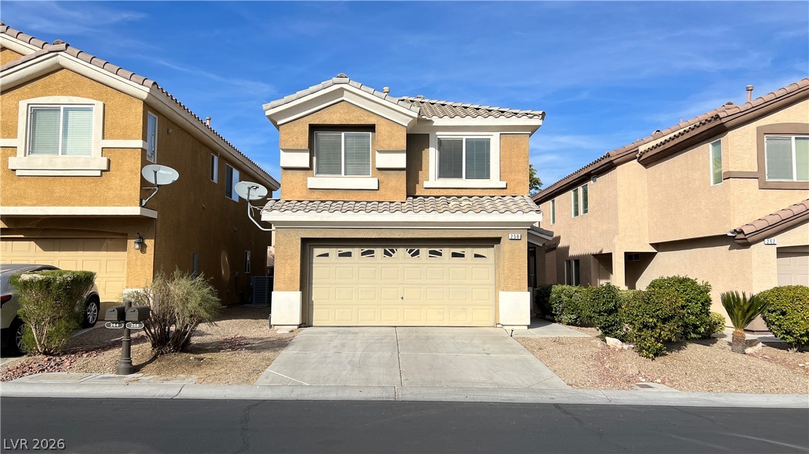 This two-story home features an attached garage and a neatly maintained front yard.